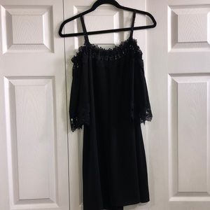 Black dress. Open at the shoulders. Has adjustable straps